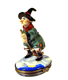 Limoges box witch wearing green dress on broom
