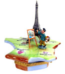 artist painting Eiffel Tower on French map