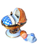 swinging cradle with blue blanket and baby boy
