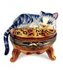 gray tabby cat on leopard print stool