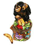 Limoges box chimp on stump with banana